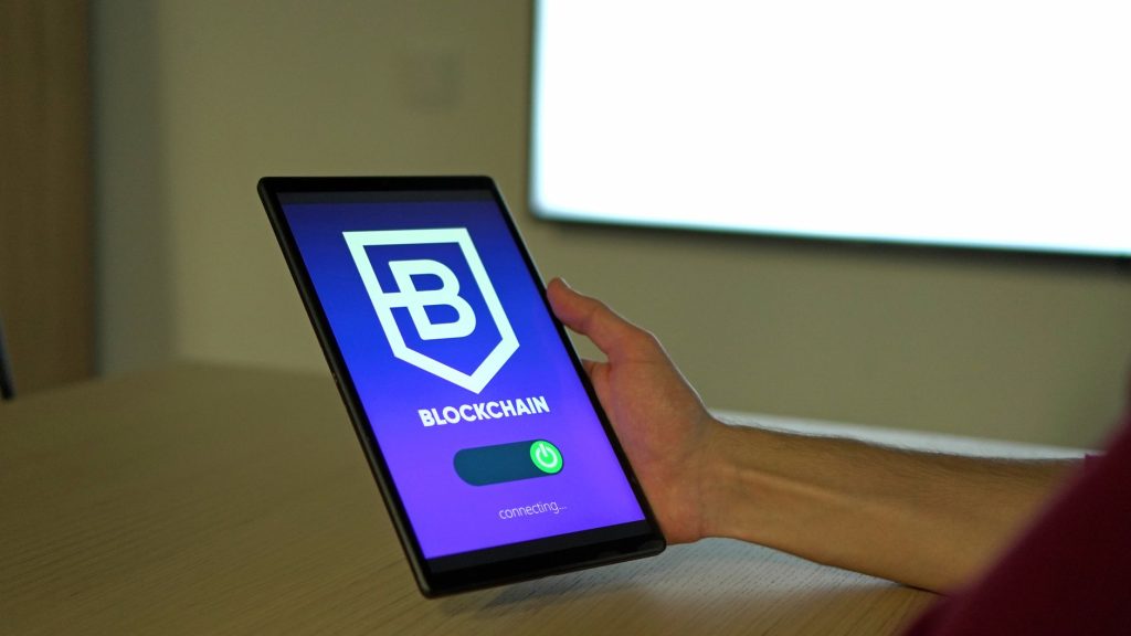 BC amplia supervisão sobre prestadoras de serviços de ativos virtuais Pessoa segura um tablet que exibe uma representação de conexões em blockchain.